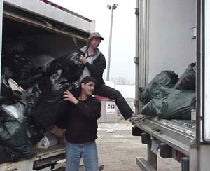 Original curbside clothing in bags being loaded for transport